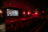 Ein leerer Kinosaal in der Schauburg in Karlsruhe mit roten Sesseln. Auf der Leinwand läuft ein Film zu 100 Jahren Volkswohnung.